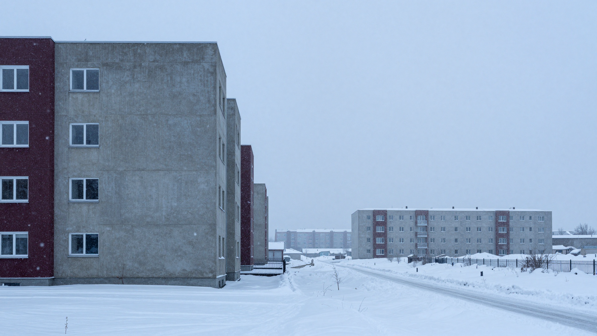 Snowy Residential Apartment Buildings Under a Pale Winter Sky
