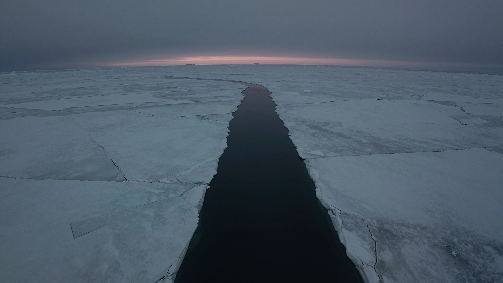 Dark Water Channel Through Vast Frozen Ice Field at Twilight