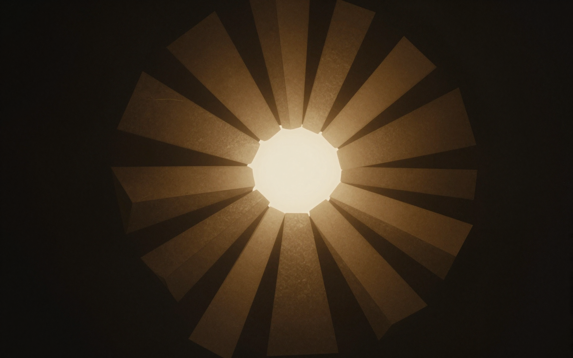 Abstract Golden Sunburst Radiating Through Dark Shadows